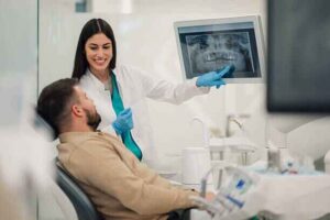 Professional dentist in clinic discussing oral health treatments
