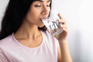 Swishing a warm saltwater rinse to soothe tooth inflammation