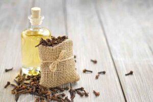 Applying diluted clove oil with a cotton ball to numb tooth nerve pain
