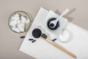 Four natural teeth whitening ingredients we tested: baking soda, coconut oil, activated charcoal, and apple cider vinegar.